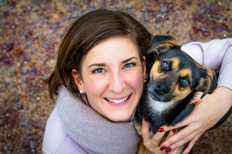 A woman holding her dog