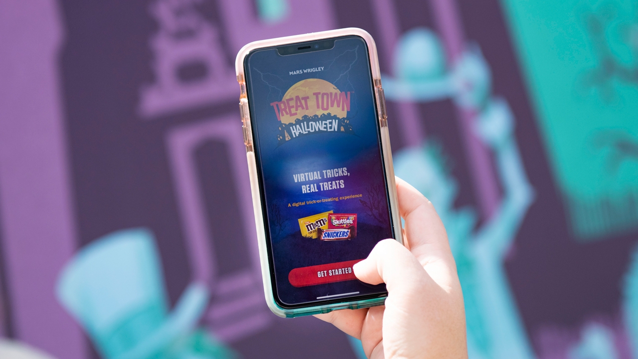Phone showing Halloween TREAT TOWN app.