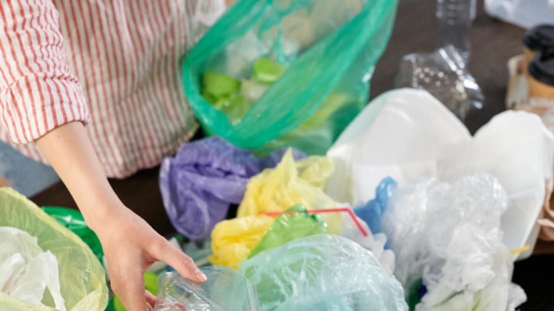 Person organizing plastic bags for recycling