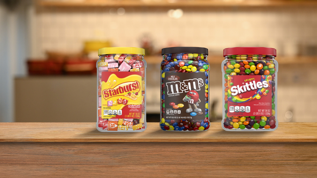 Recycled Starburst, M&M's and Skittles bulk packaging on a kitchen counter