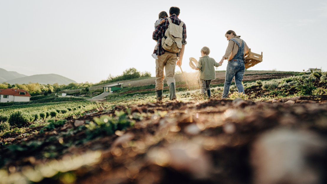 A family walking outside in a field
