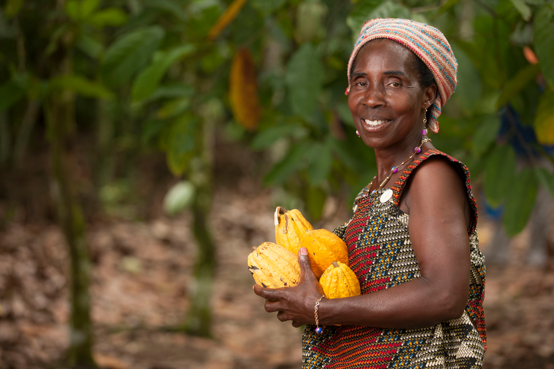 A farmer proudly displays her crops