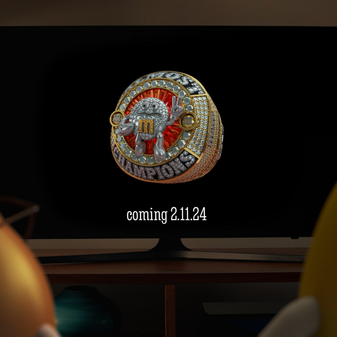 Two M&M's characters watching the M&M'S Almost Champions Ring of Comfort on TV