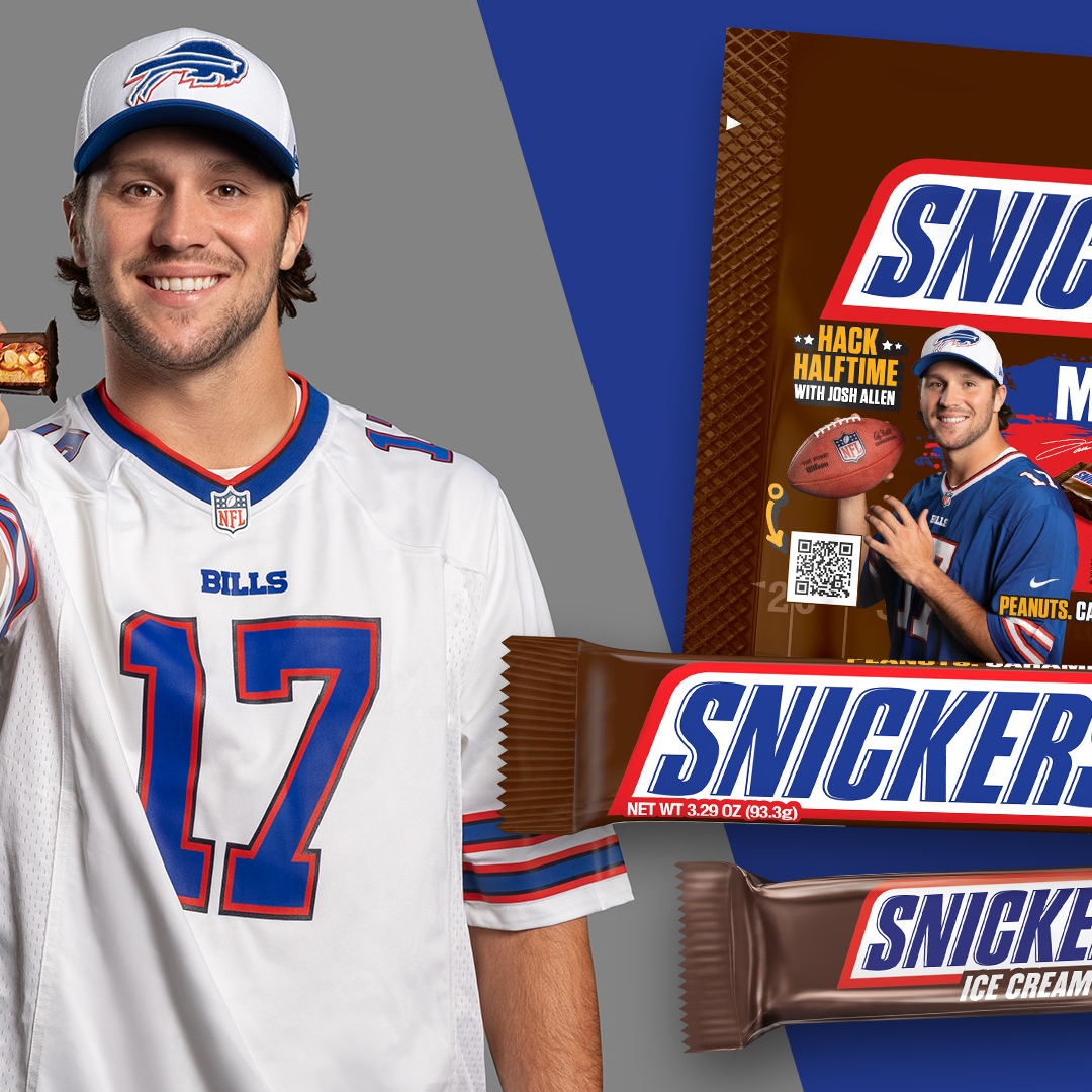Josh Allen holding a SNICKERS bar