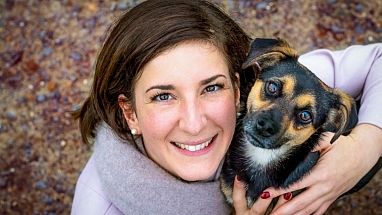 A woman holding her dog