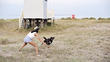 Woman and her dog on the beach