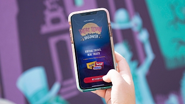 Phone showing Halloween TREAT TOWN app.