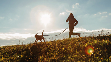 Man running with his dog.