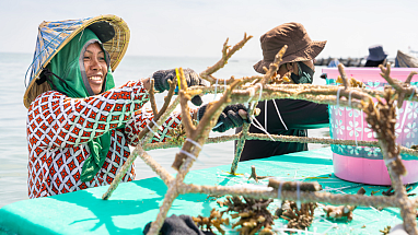 A team member of The Big Build smiling and assembling reef star