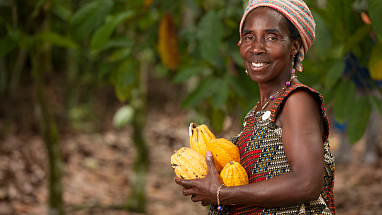 A farmer proudly displays her crops