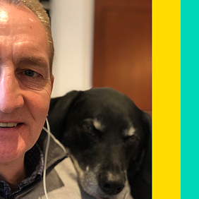 Mars CEO Grant F. Reid listens to music while sitting with his dog.