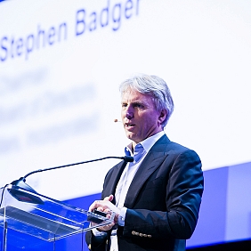 Director and former Chairman of the Mars Board, Stephen Badger, speaking on stage at a conference.