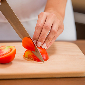 Chef cutting tomatoes