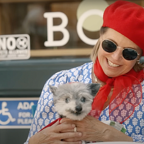 Katie Couric holding Gina, the dog 