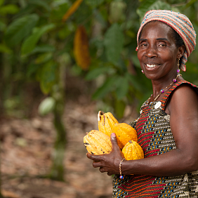 A farmer proudly displays her crops