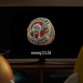 Two M&M's characters watching the M&M'S Almost Champions Ring of Comfort on TV